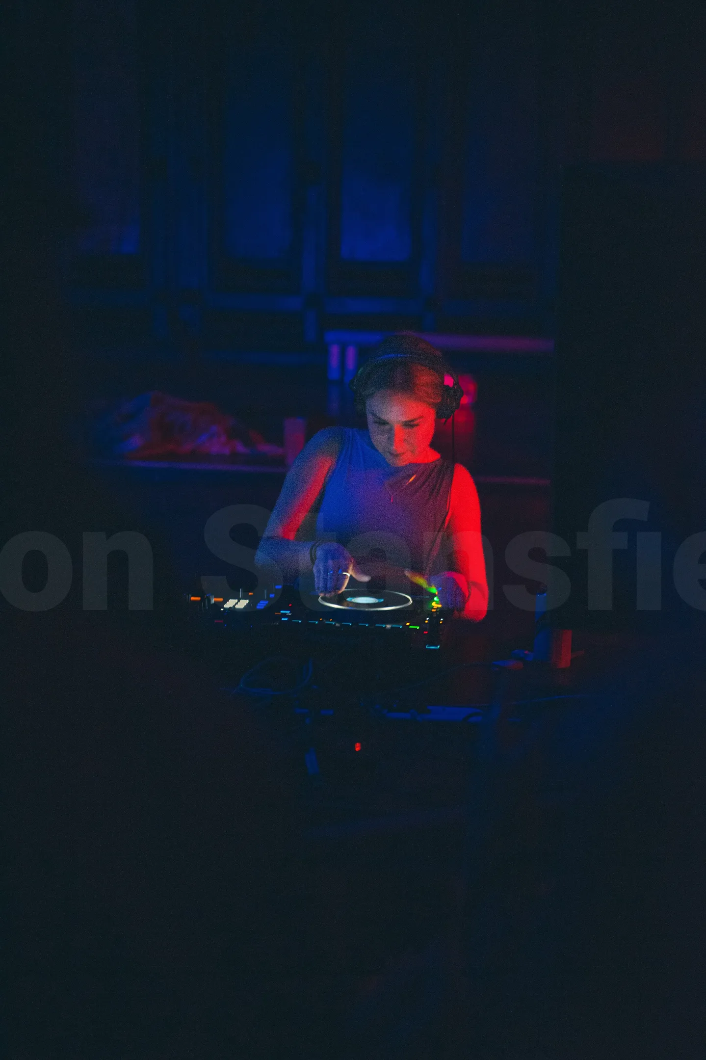 A photo of a DJ playing in a nightclub