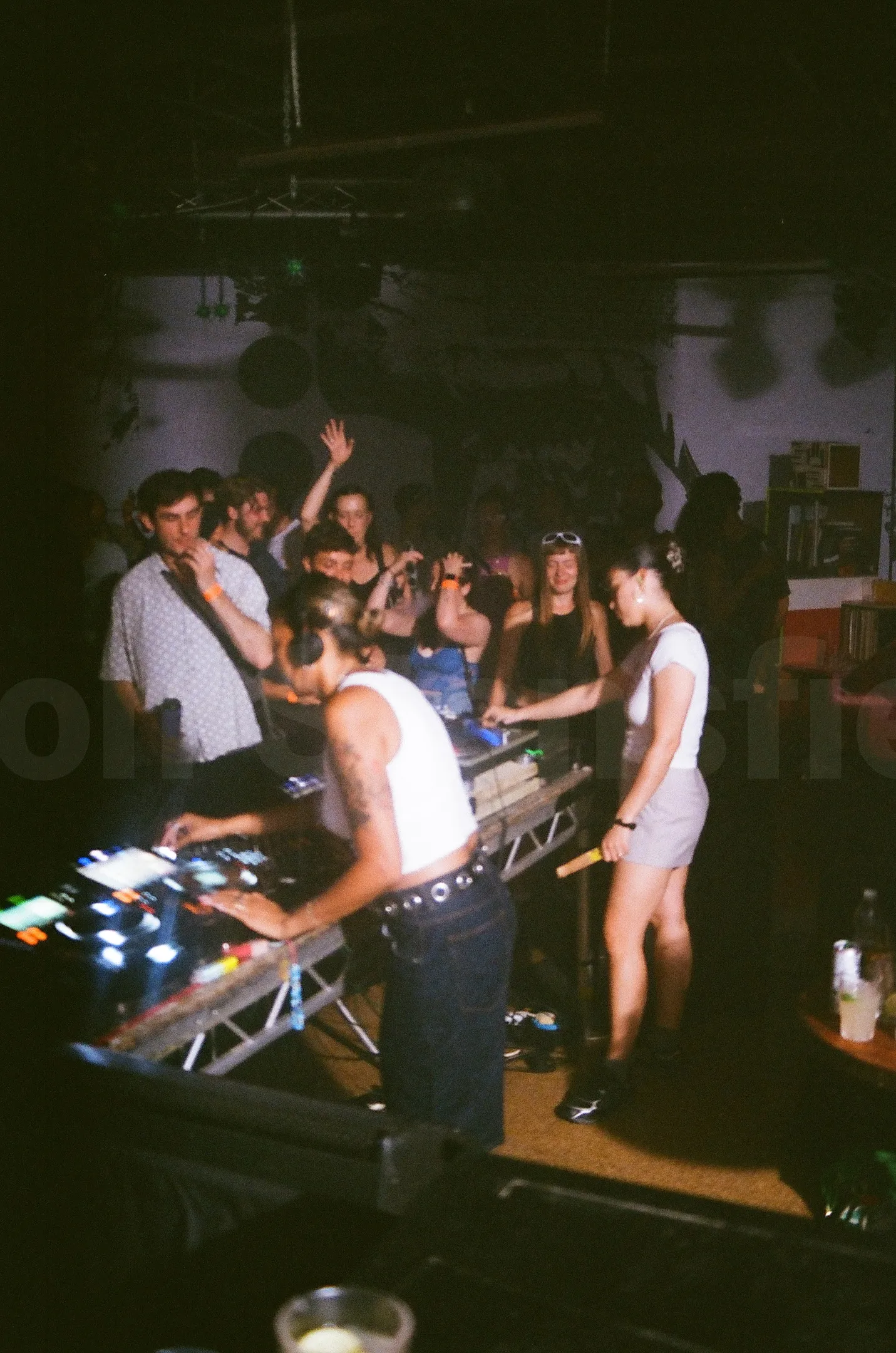 A photo of a DJ playing in a nightclub